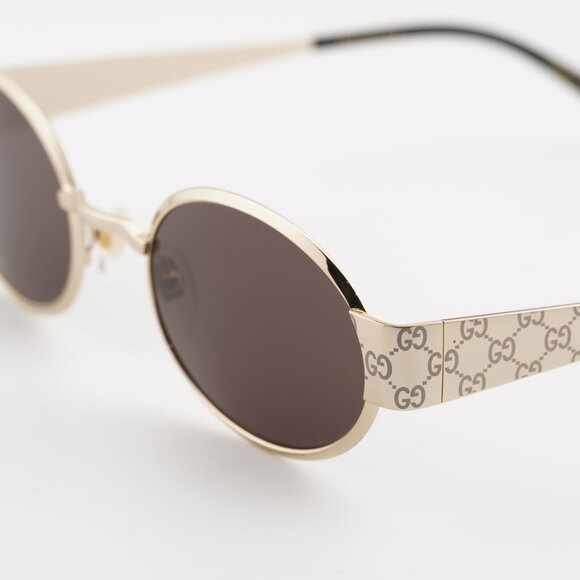 Gucci GG1854S 005 Sunglasses Shiny Gold with GG Pathern Oval Frame, Brown Lenses